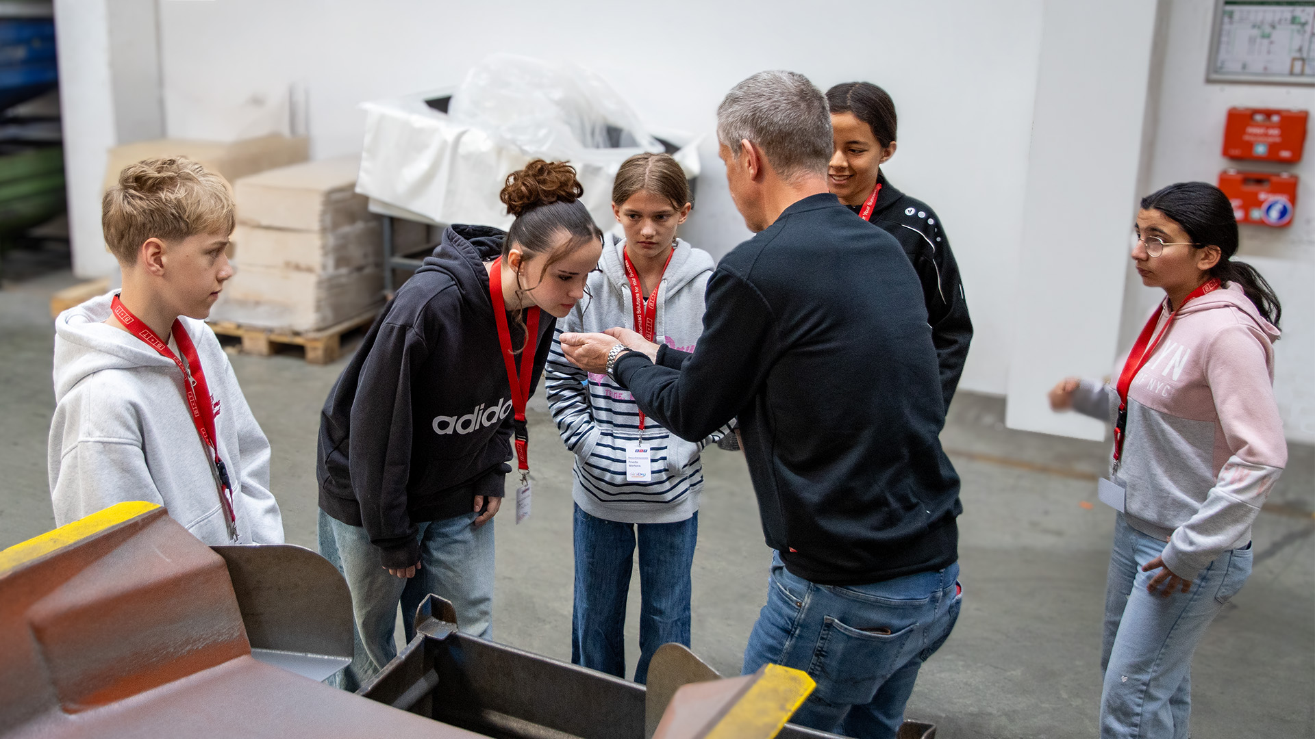 Galvanik mit allen Sinnen erleben: CTO Edgar Kaufmann lässt die Jugendlichen an den frisch beschichteten Bauteilen schnuppern